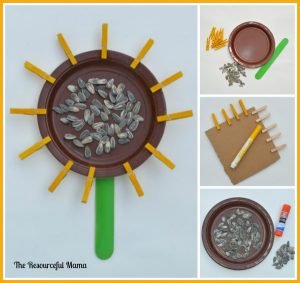 Kids' sunflower craft project. You need: jumbo craft stick, mini clothespins, sunflower seeds, small brown paper plate, green paint, yellow marker, and glue.