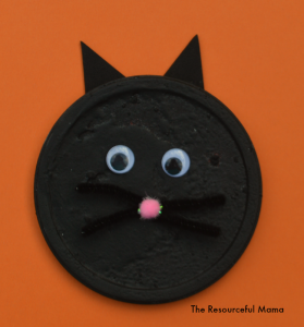Black cat kid craft perfect for Halloween. It's made from a recycled product and DIY puffy paint.