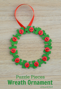 Transform old puzzle pieces and buttons into a lovely kid make wreath ornament for the Christmas tree.