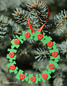 Transform old puzzle pieces and buttons into a lovely kid make wreath ornament for the Christmas tree.