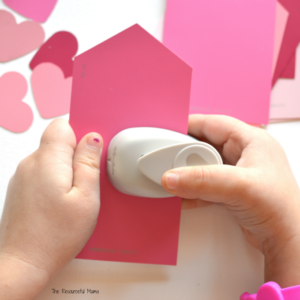 Turn heart craft punches and paint chips into a Valentine's Day fine motor activity for young kids.