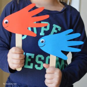 Cute handprint fish puppets inspired by Dr. Seuss One Fish Two Fish Red Fish Blue Fish. kid craft | book inspired craft | book extension activity 