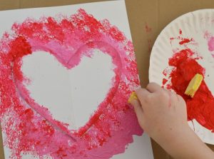 Create a Valentine's art project using sponges to paint a heart. 