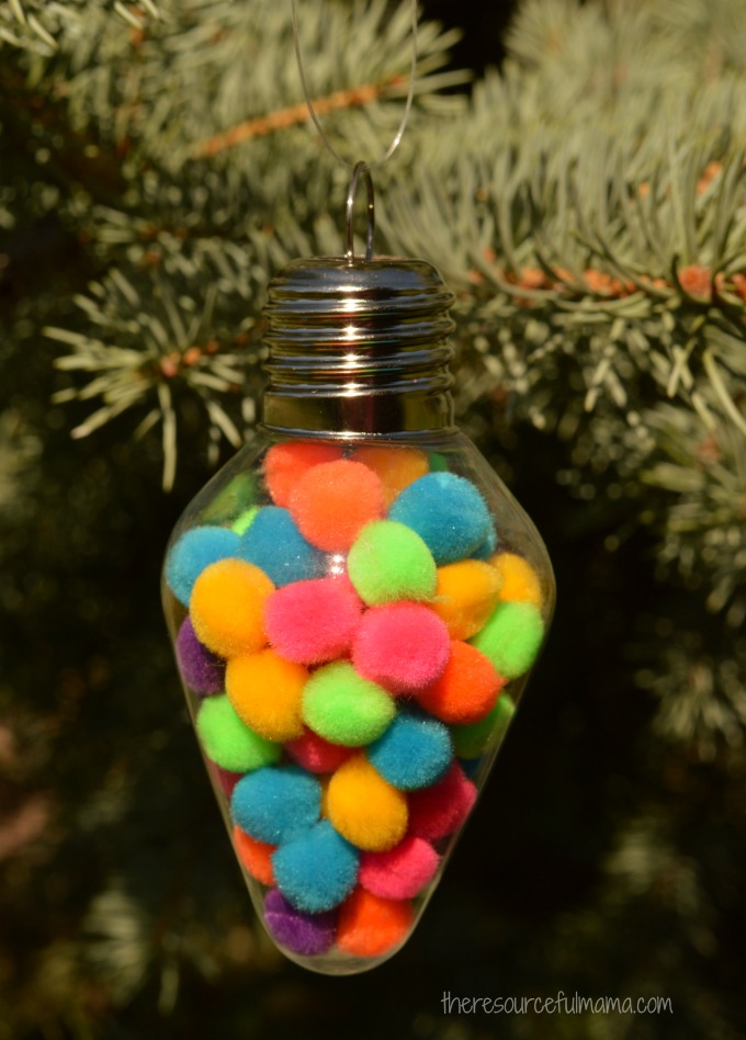 This Pom Pom Filled Christmas Ornament is a super simple and inexpensive ornament for kids to make that works on fine motor skills and hand-eye coordination.
