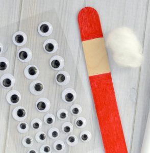The whimsy pipe cleaner hat on this Craft Stick Santa Ornament is so fun! Kids will love to make this Santa ornament and hang it on the Christmas tree