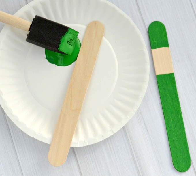 Kids will love creating this fun elf ornament from a craft stick and pipe cleaner to hang on the Christmas tree.