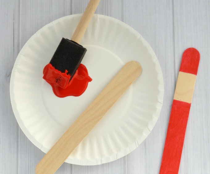 The whimsy pipe cleaner hat on this Craft Stick Santa Ornament is so fun! Kids will love to make this Santa ornament and hang it on the Christmas tree