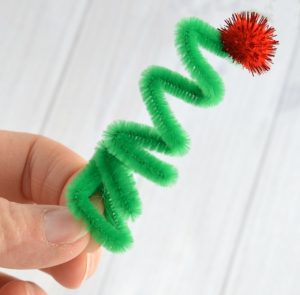 Kids will love creating this fun elf ornament from a craft stick and pipe cleaner to hang on the Christmas tree.