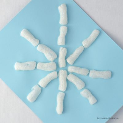 Super easy winter snowflake craft for kids using packing peanuts.