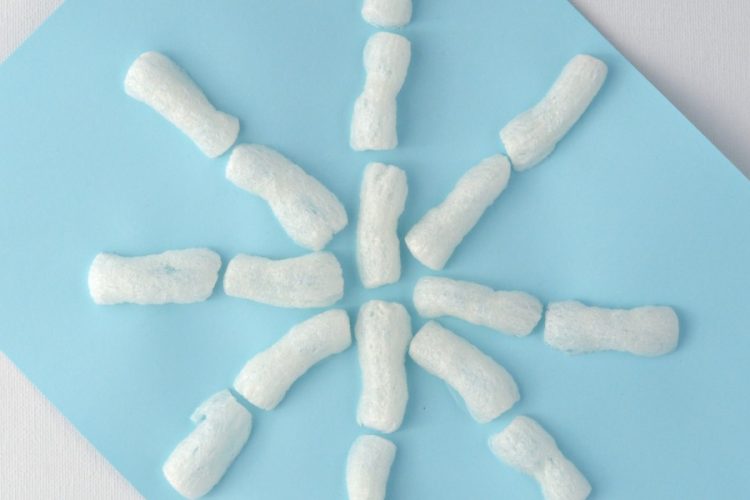 Super easy winter snowflake craft for kids using packing peanuts.